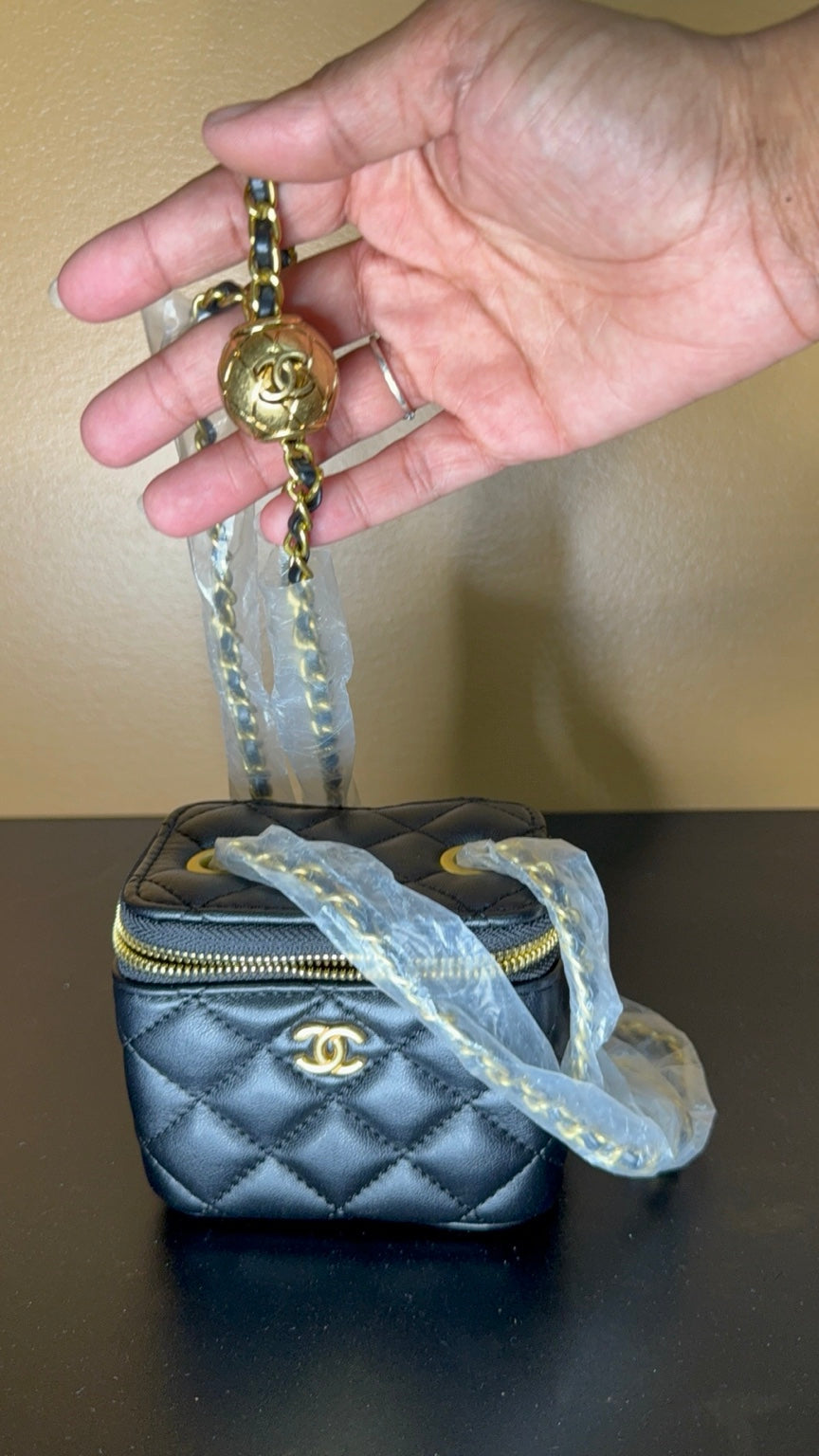 Black Chanel vanity bag chain detail